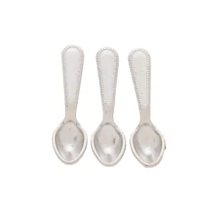 Detail of vintage silver zinc alloy mini spoons with beaded edge texture for DIY jewelry