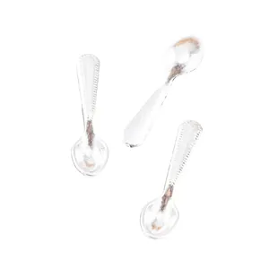 Close-up of three silver miniature spoons with beaded edges for DIY jewelry making