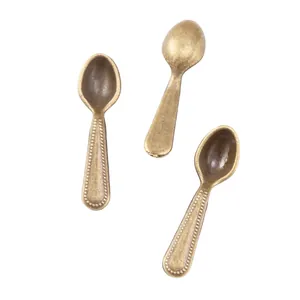 Detail of vintage bronze zinc alloy spoon charms with beaded edges for DIY jewelry