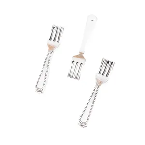 Macro detail of miniature zinc alloy forks with beaded relief handles for DIY crafts