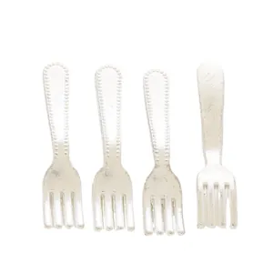 Detailed macro view of 4-piece vintage silver miniature alloy forks for DIY crafts