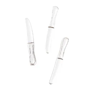 Close-up of vintage zinc alloy miniature knives with ornate beaded relief handles