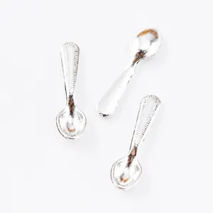 Detail showing vintage silver zinc alloy mini spoon charms with beaded handle texture