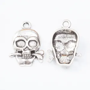 Vintage zinc alloy skull pendants with bone in mouth, showing front and back views