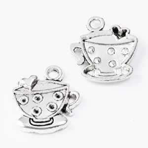 Close-up of vintage silver cup charms with heart detail for DIY jewelry making