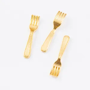 Detailed view of three mini gold-plated alloy fork pendants for DIY jewelry making crafts