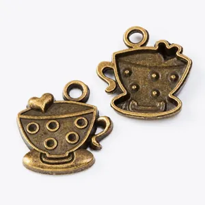 Close-up of vintage bronze cup pendants with heart details for DIY jewelry making
