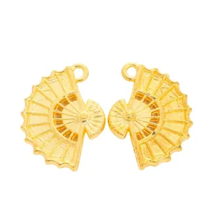 Close-up of golden vintage fan-shaped alloy charms with detailed radial textures for DIY jewelry