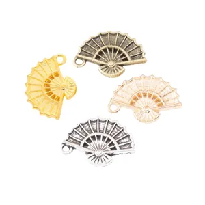Set of four vintage zinc alloy fan charms in gold, silver, bronze, and rose gold finishes