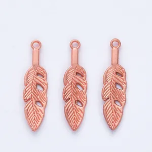 Three rose gold feather pendants with intricate hollow patterns and top rings for DIY