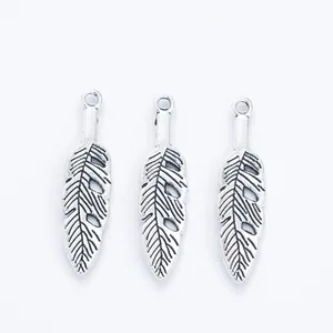 Three vintage zinc alloy feather pendants with antique silver finish for DIY jewelry crafting
