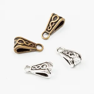 Detailed view of vintage alloy pendant connectors in bronze and silver finishes