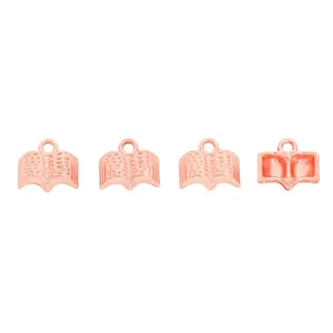 Close-up of four rose gold book-shaped zinc alloy charms for DIY jewelry making