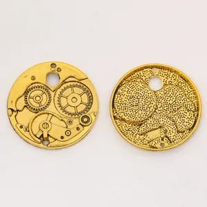 Macro detail of vintage gold steampunk gear pendant showing front and back mechanical textures