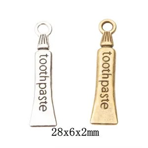 Silver and bronze vintage alloy toothpaste charms with hooks, size 28x6x2mm