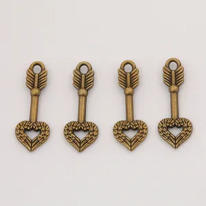 Set of four vintage bronze heart and arrow pendants for DIY jewelry making and crafts