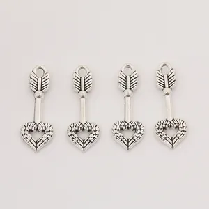 Set of four vintage silver heart-shaped pendants with arrow and wing design for jewelry making