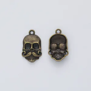 Vintage bronze zinc alloy skull pendant with mustache detail showing front and back views