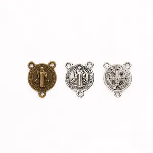 Macro detail of St. Benedict vintage zinc alloy charms with triple holes and relief patterns
