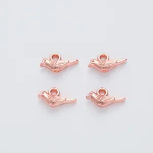 Set of four rose gold vintage bird charms with detailed wings for DIY jewelry making