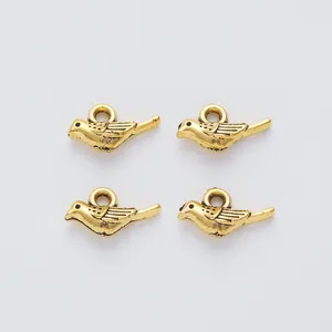 Set of four vintage gold bird alloy pendants for DIY jewelry making and crafting