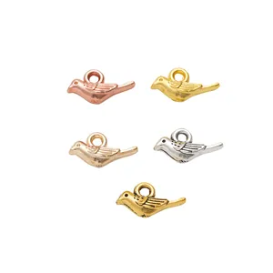 Five assorted vintage bird alloy pendants in rose gold, silver and bronze for DIY jewelry