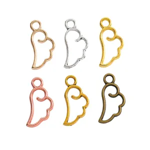 Set of six vintage alloy wing pendants in various metallic finishes for DIY jewelry making