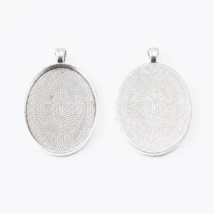 Macro detail of silver oval bezel tray with textured back for DIY jewelry pendants