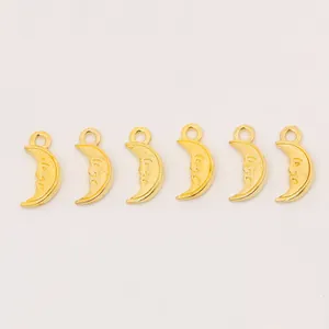 Detail view of gold alloy crescent moon face charms with top hanging loops for jewelry making