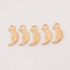 Detailed view of five crescent moon pendants with carved faces for DIY jewelry making