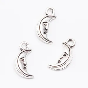Three pieces of vintage silver alloy crescent moon charms with smiling faces for DIY jewelry