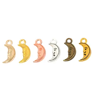 Set of six alloy crescent moon face charms in various vintage metallic finishes