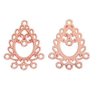 Macro detail of rose gold teardrop alloy pendant with hollow filigree and 6 connector loops