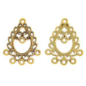Macro detail of antique gold teardrop hollow alloy pendant connectors for jewelry making