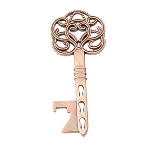 Close-up of vintage bronze heart-shaped key bottle opener with ornate Victorian patterns