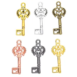 Set of 6 vintage alloy key pendants in gold, silver, bronze, and rose gold finishes