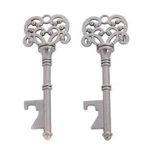 Macro detail of two vintage alloy key bottle openers with intricate floral carvings