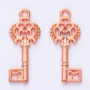 Pair of rose gold vintage alloy key pendants with floral openwork for DIY jewelry making