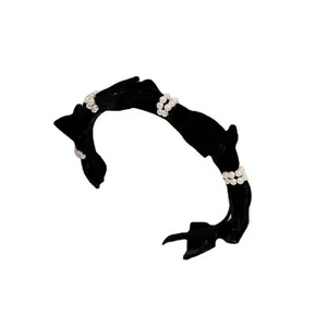 Elegant black velvet headband with French vintage bow, pearls and pleat details