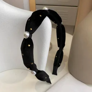 Vintage black velvet headband featuring elegant white pearls and gold metal stud accents