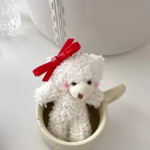 Cute white plush bear with red bow in a ceramic mug, sweet vintage aesthetic hairpin