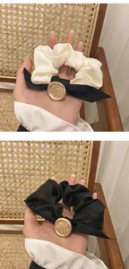 Detail of French vintage scrunchies with elegant bow and gold embossed metal emblems
