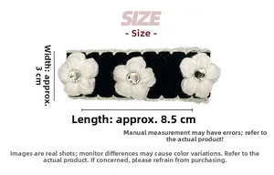 Detailed view of knitted camellia flower hair clip with size dimensions 8.5cm by 3cm