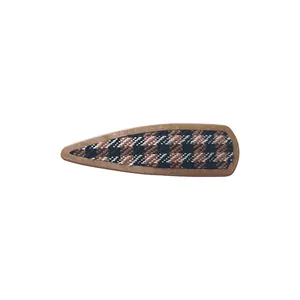Classic houndstooth fabric BB hair clip with brown faux leather trim on white background
