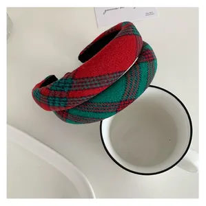 Close-up of thick plaid headbands in red and green colors with wool texture and retro style