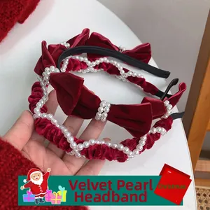 Detail of red velvet Christmas headbands with faux pearls and festive bow design