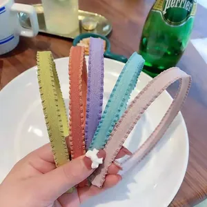 Set of five pleated fabric headbands in vibrant candy colors with wavy scalloped edges