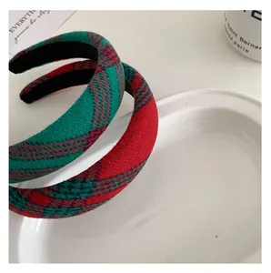 Detail of red and green plaid headband with thick sponge padding and wool fabric texture