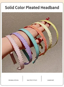 Detailed view of colorful pleated fabric headbands in pink, purple, blue, and yellow
