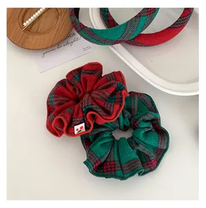 Detail of red and green plaid headband and scrunchies with cherry embroidery tag